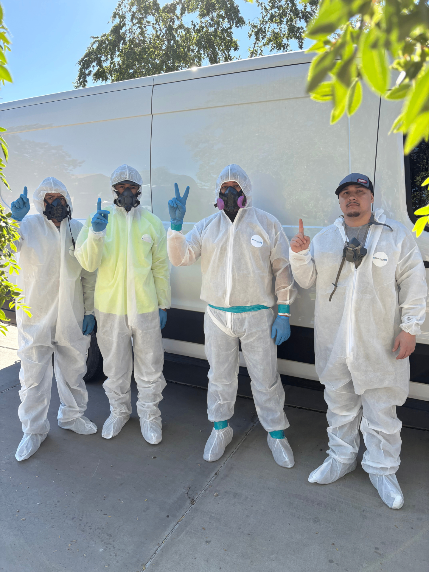 Triology Restorations technicians in protective gear ready to respond to property damage emergencies